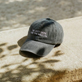 Cargar la imagen en la vista de la galería, Grey washed embroidered cap with the phrase "I'm Just Here for the Mezcal" by Mezcal Mitre resting on a stone surface.
